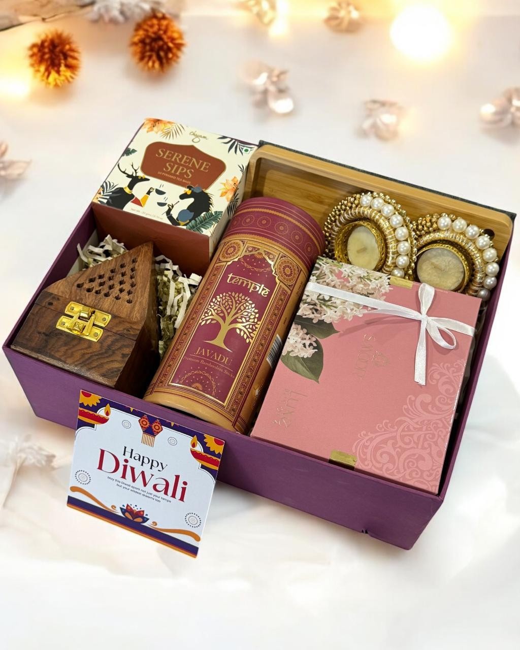 Plum gift box with treats and decorative festive keepsakes