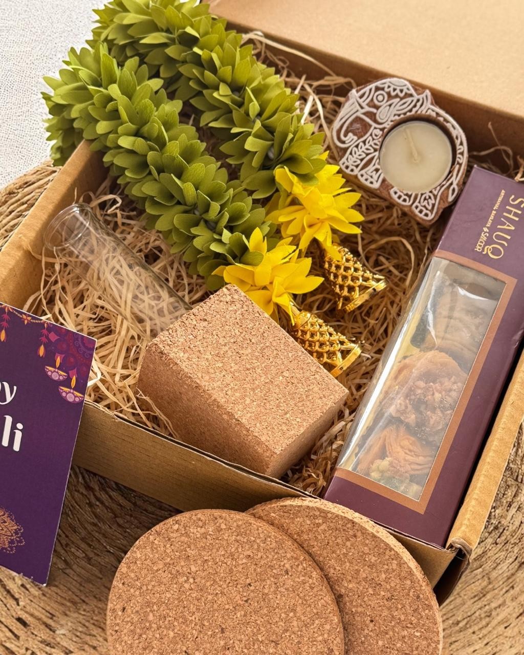 Botanical hamper with green foliage, cork accessories and boxed gifts