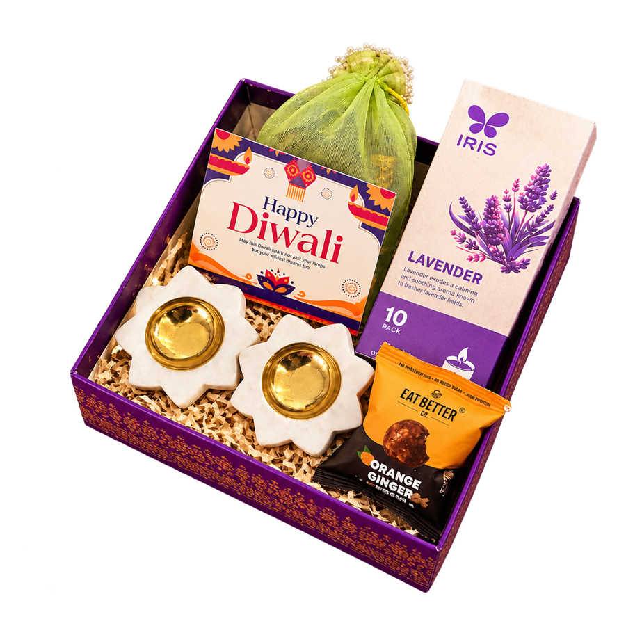 Purple Diwali hamper with flower-shaped diyas, lavender fragrance, a green pouch and festive treats