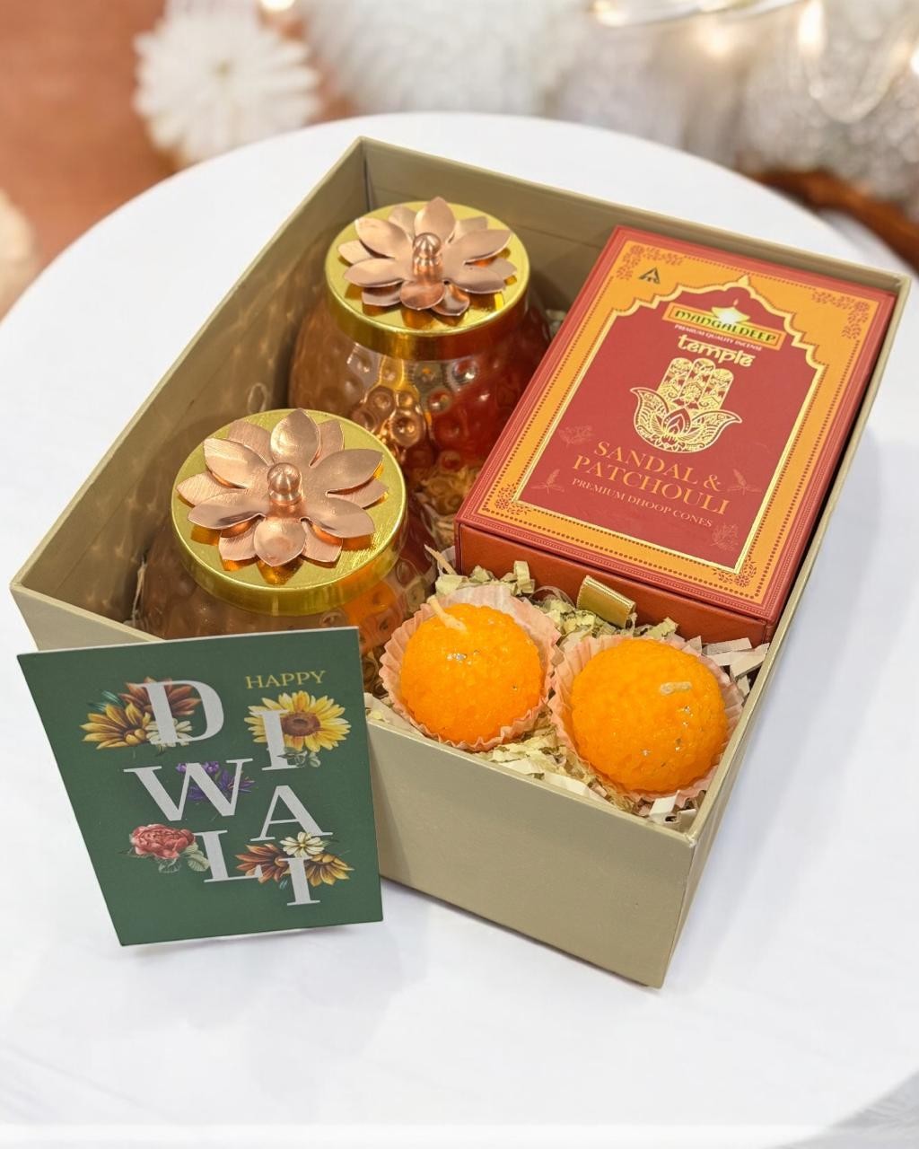 Ivory hamper with decorative jars, a red box and orange sweets