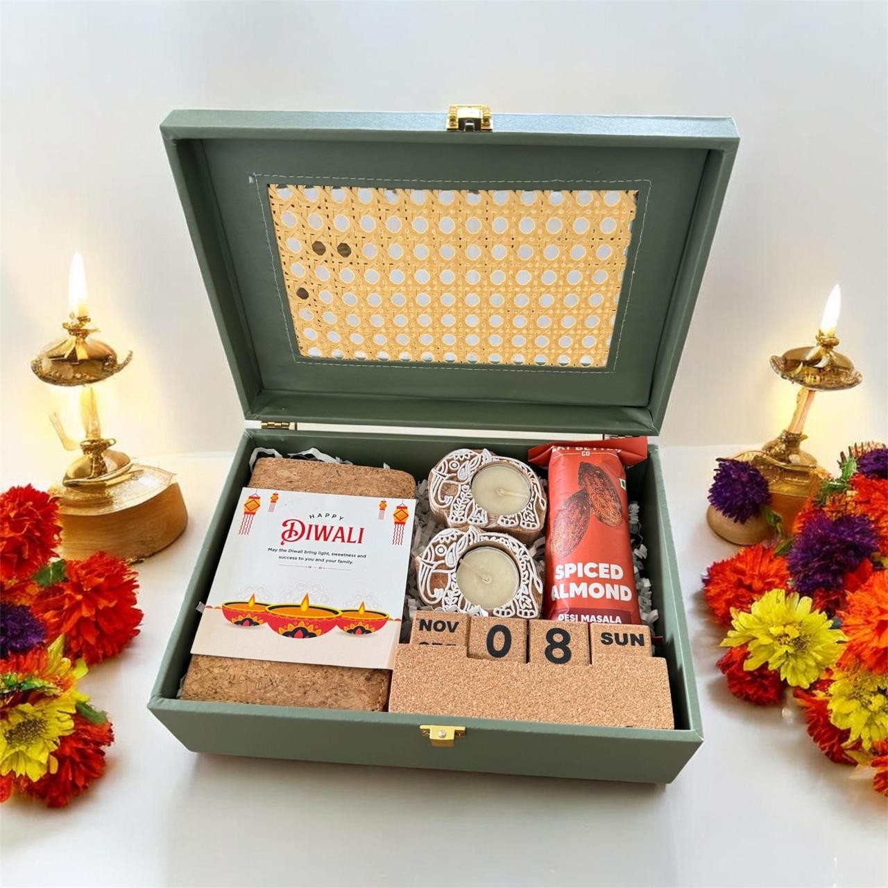Sage green gift trunk arranged with festive treats and keepsakes